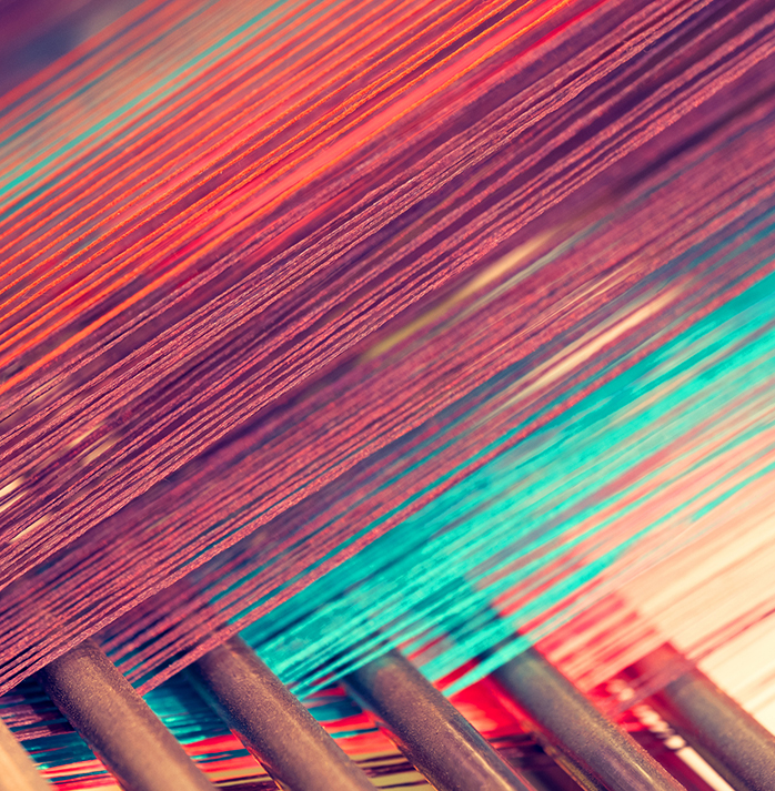 Close-up of colorful threads on a loom in a fabric mill